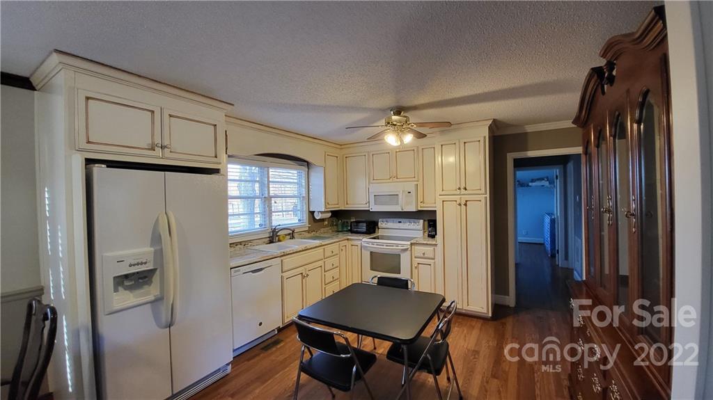 3518 Upper White Store Road Peachland, NC 28133 - Photo 17 of 33 a kitchen with white cabinets and stainless steel appliances