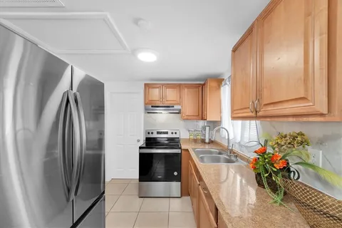 a kitchen with a sink stove and cabinets