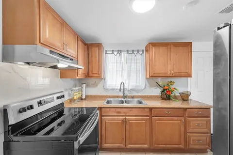 a kitchen with a sink cabinets and stainless steel appliances