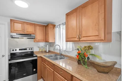 a kitchen with a sink cabinets and a window