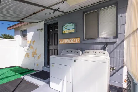 a view of a chair and table in backyard of the house