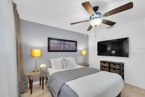 a bedroom with a bed couch and window