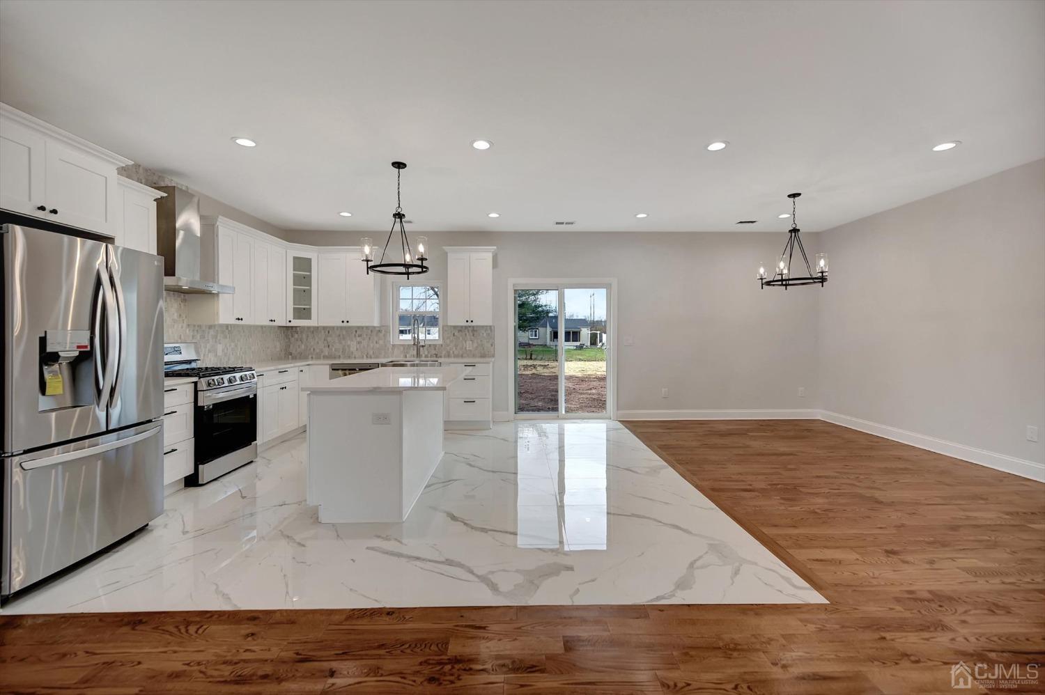 55 Walnut Street Edison, NJ 08817 - Photo 12 of 40 a kitchen with stainless steel appliances granite countertop a refrigerator a stove and a sink