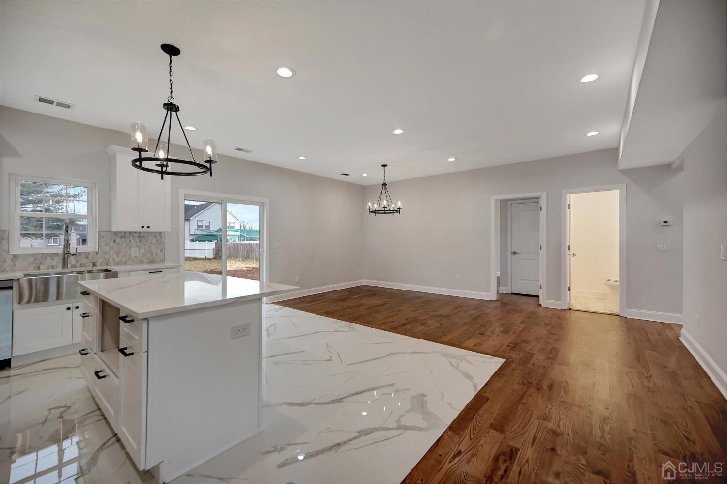 55 Walnut Street Edison, NJ 08817 - Photo 13 of 40 a kitchen with a sink chandelier and wooden floor