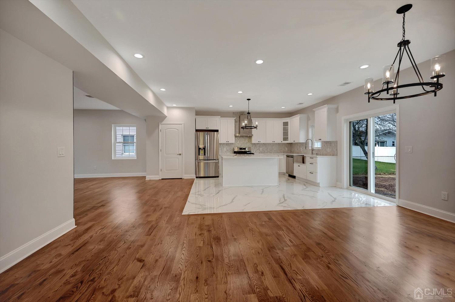 55 Walnut Street Edison, NJ 08817 - Photo 14 of 40 a view of large kitchen with wooden floor and windows