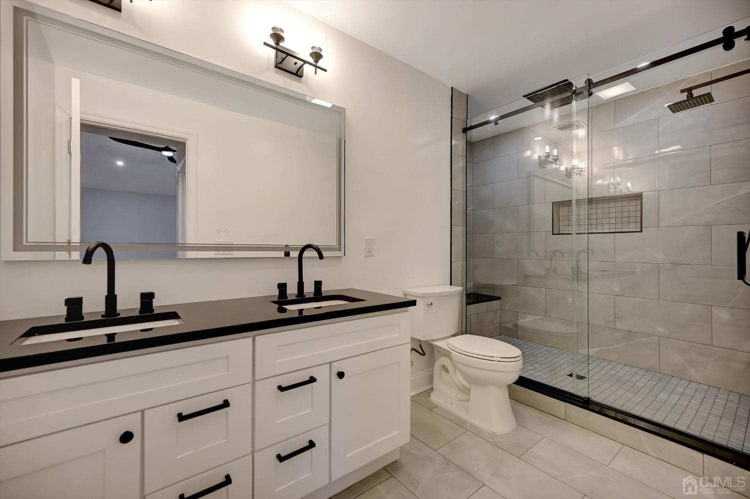 55 Walnut Street Edison, NJ 08817 - Photo 22 of 40 a bathroom with a double vanity sink toilet and shower