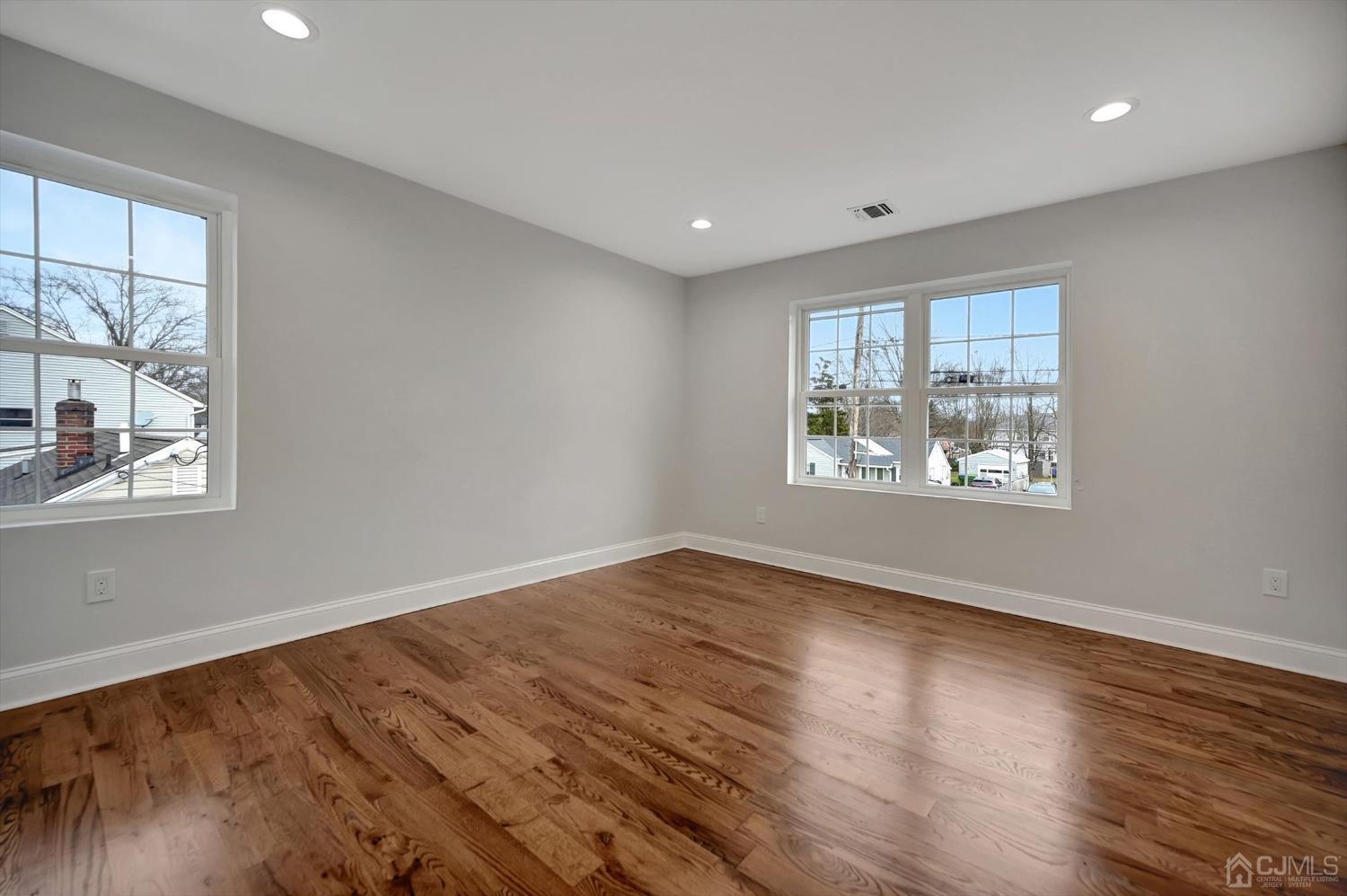 55 Walnut Street Edison, NJ 08817 - Photo 27 of 40 a view of an empty room with wooden floor and a window