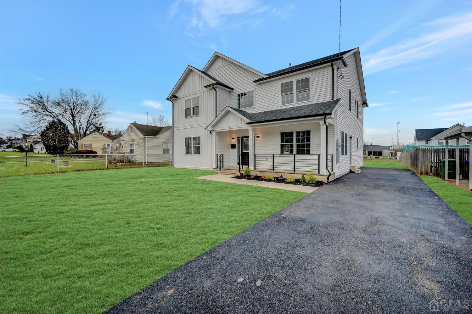 55 Walnut Street Edison, NJ 08817 - Photo 40 of 40 a view of a yard in front of a house with plants and large tree