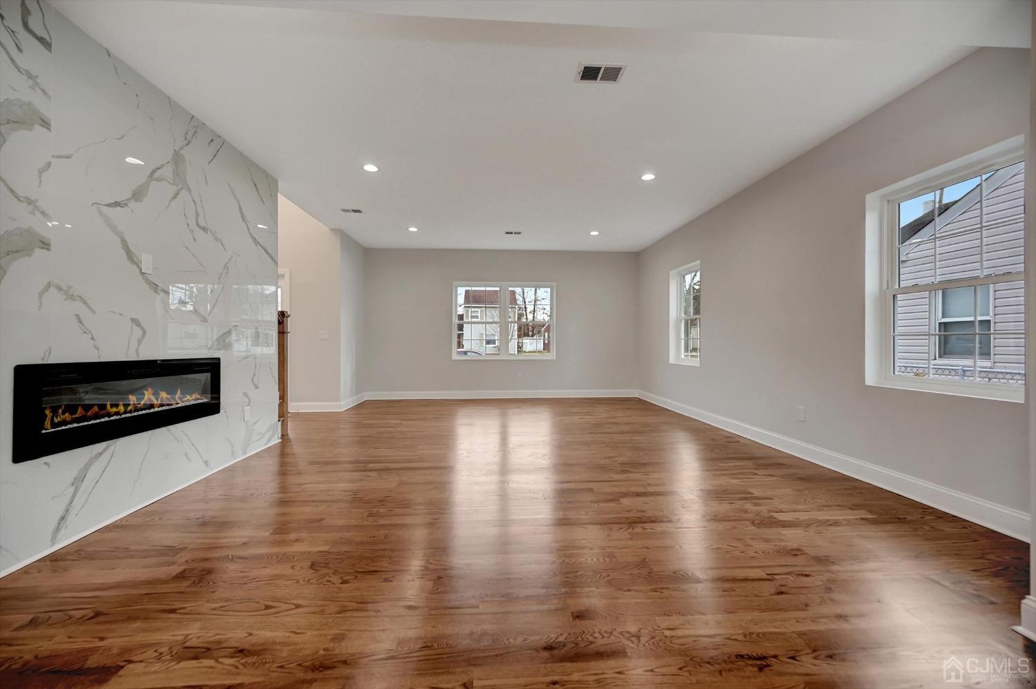 55 Walnut Street Edison, NJ 08817 - Photo 9 of 40 a view of an empty room with a fireplace and a window
