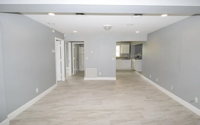 wooden floor in a room with a bathroom