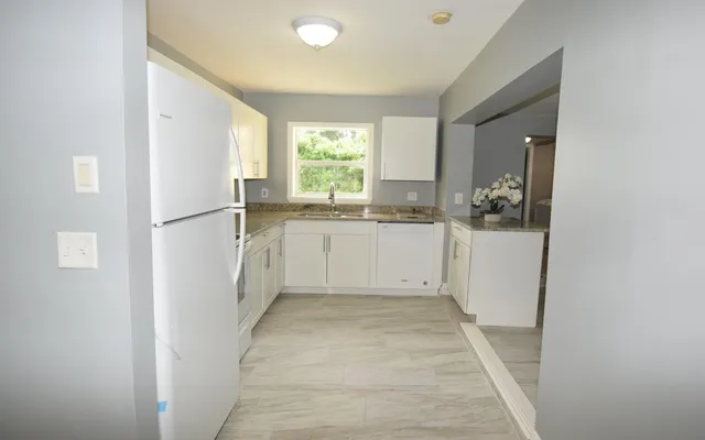a kitchen with a refrigerator a sink and dishwasher