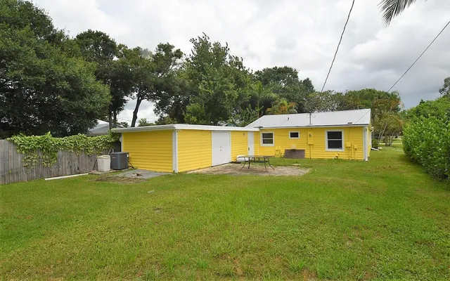 a front view of house with yard and trees