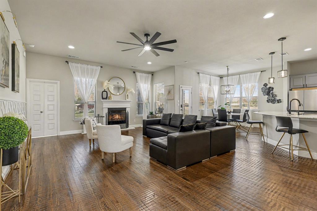 a living room with fireplace furniture and a wooden floor