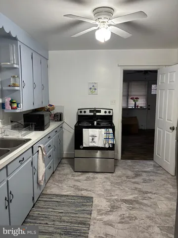 a kitchen with stainless steel appliances granite countertop a stove and a sink
