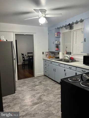 a kitchen with stainless steel appliances a sink stove and refrigerator