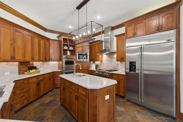a kitchen with stainless steel appliances granite countertop a sink stove and refrigerator