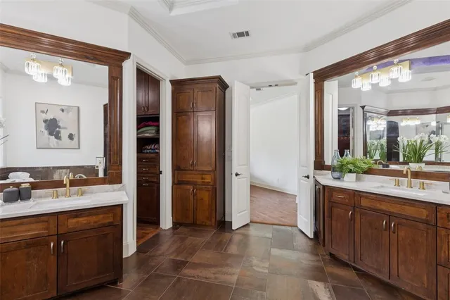 a large bathroom with a double vanity sink and a mirror