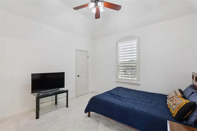 a bedroom with a bed and a television