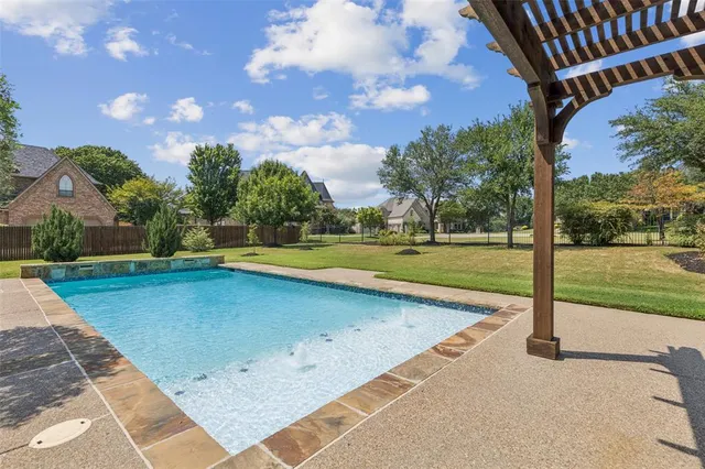 a view of a swimming pool and a yard