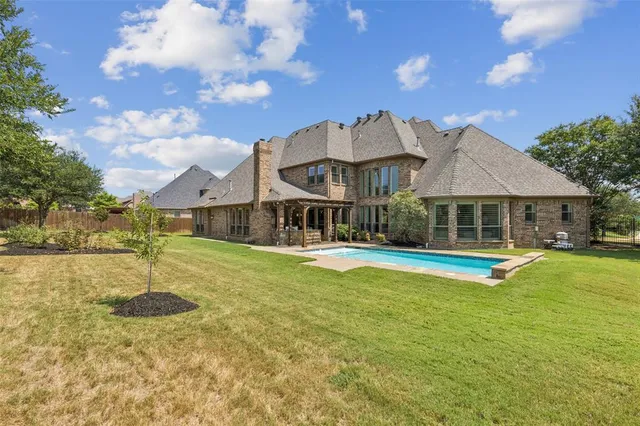 a view of a house with swimming pool and sitting area