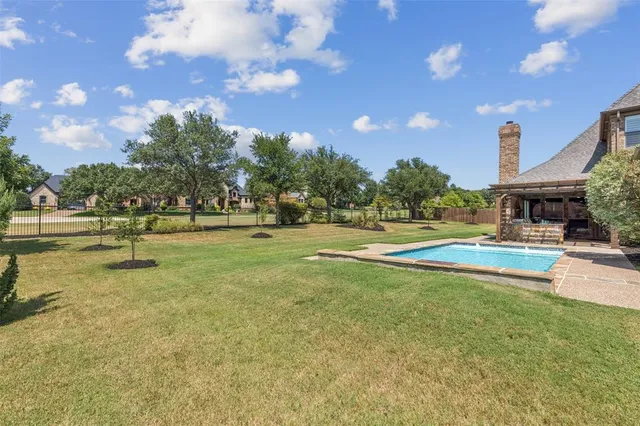 a view of a swimming pool with an outdoor space and seating