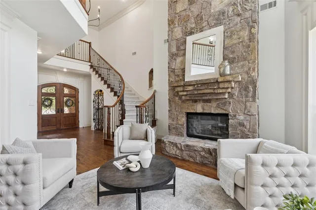 a living room with furniture a fireplace and a table