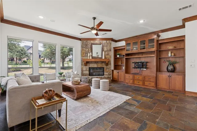 a living room with furniture a fireplace and a flat screen tv