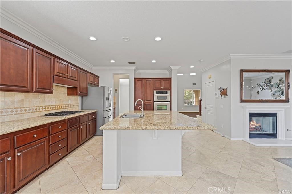 8634 Hunt Canyon Road Corona, CA 92883 - Photo 7 of 31 a large kitchen with stainless steel appliances granite countertop a large counter top and a stove top oven
