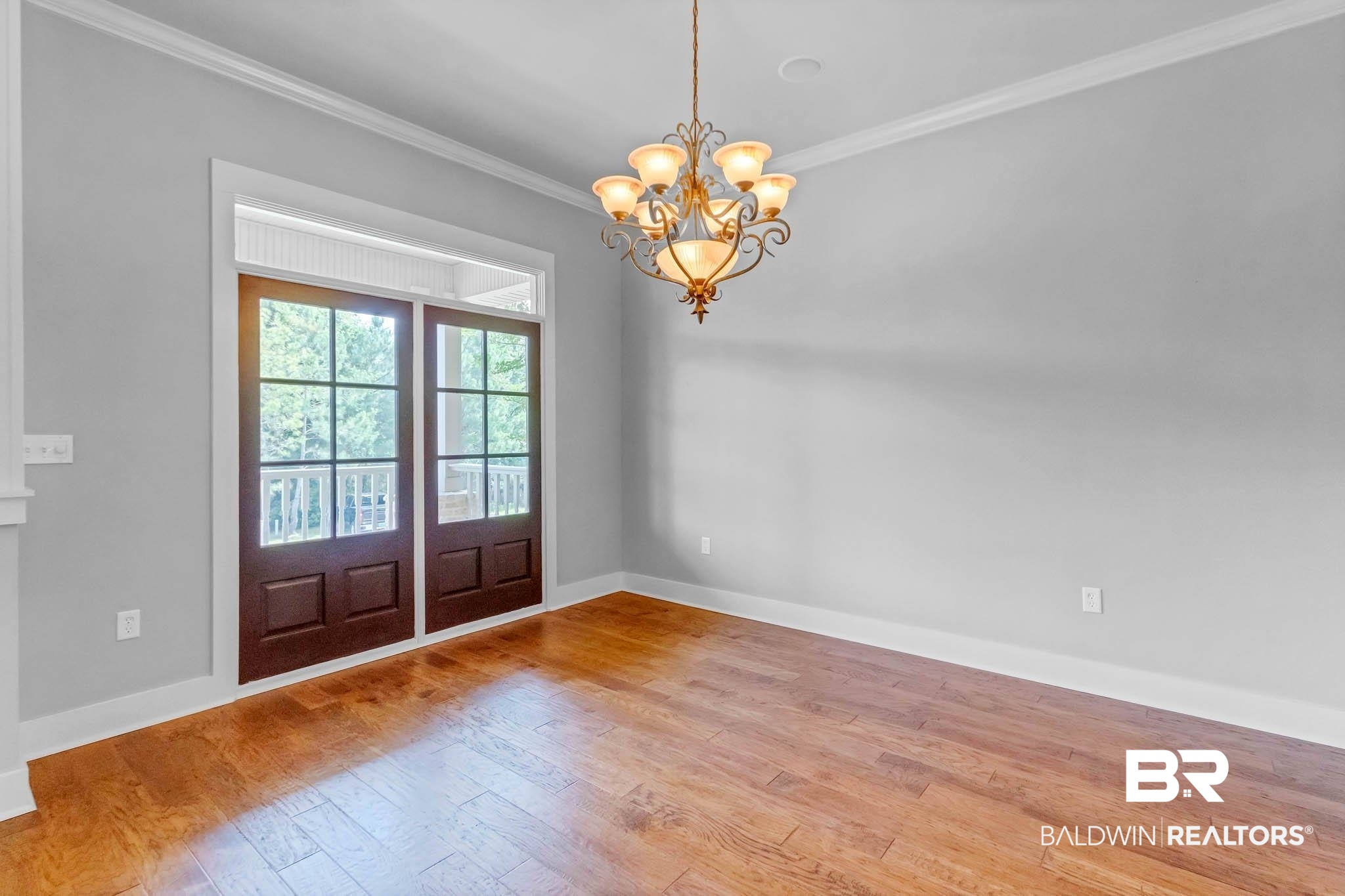 7854 Raegan Lane Daphne, AL 36527 - Photo 29 of 70 Dining area featuring crown molding, wood finished floors, baseboards, and a chandelier