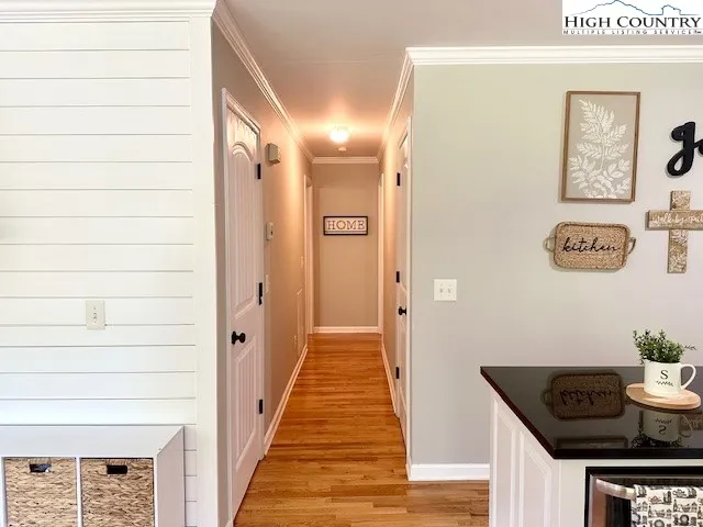 a hallway with painting on the wall