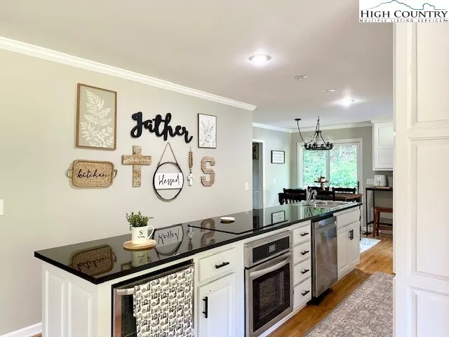 a kitchen with a sink stove and cabinets