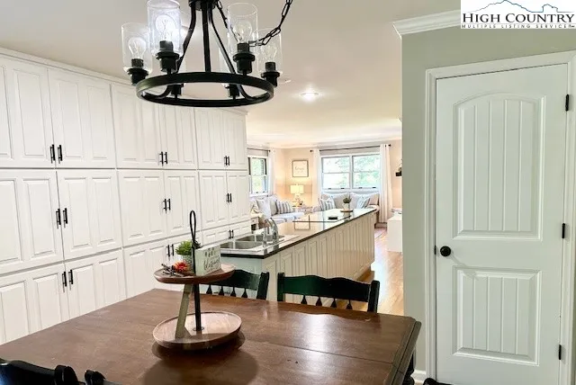 a kitchen with stainless steel appliances granite countertop a sink a stove and white cabinets