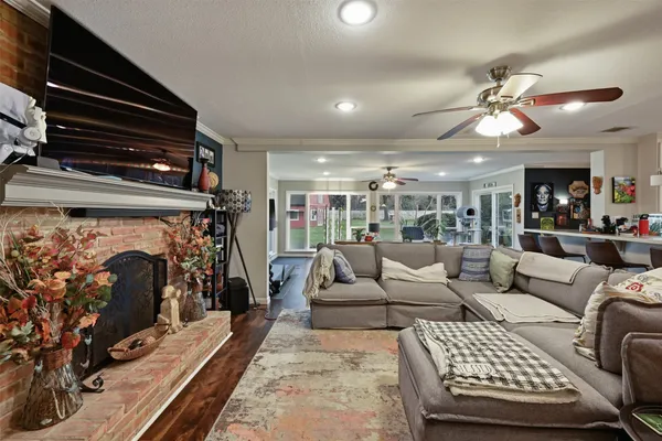 a living room with furniture and a book shelf