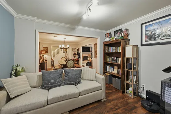 a bedroom with a bed a dresser and a window