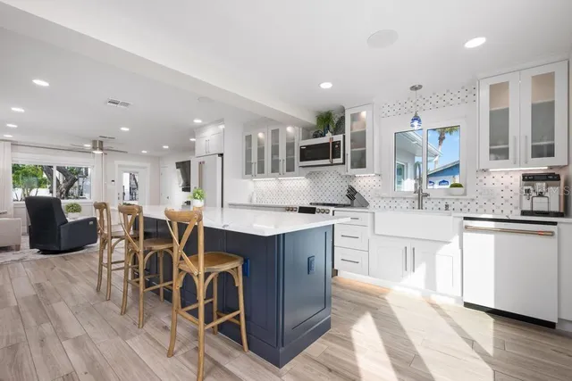 a kitchen with a sink and wooden floor