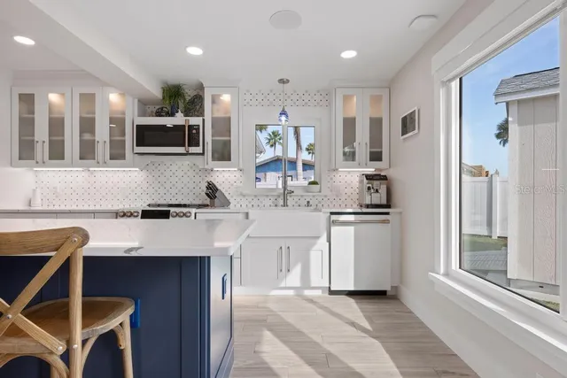 a kitchen with a stove sink and cabinets
