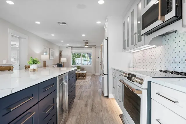 a bedroom with a bed a flat screen tv and a window