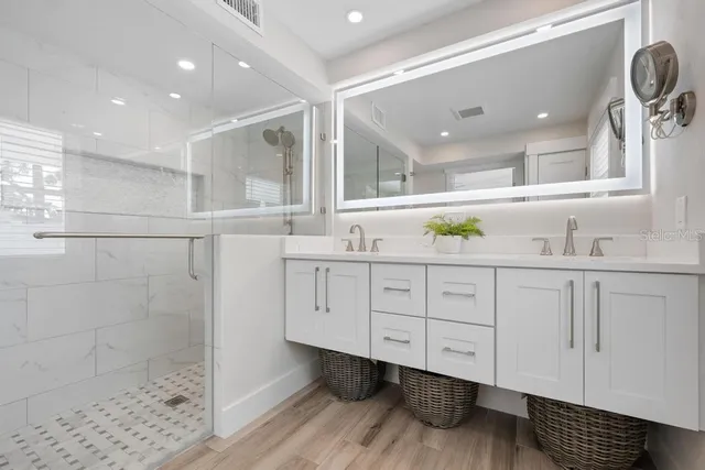 a bedroom with a large bed and a ceiling fan