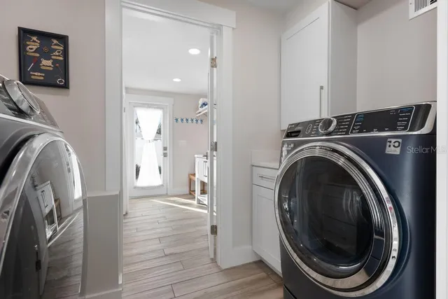 a patio with couches and a potted plant on the road