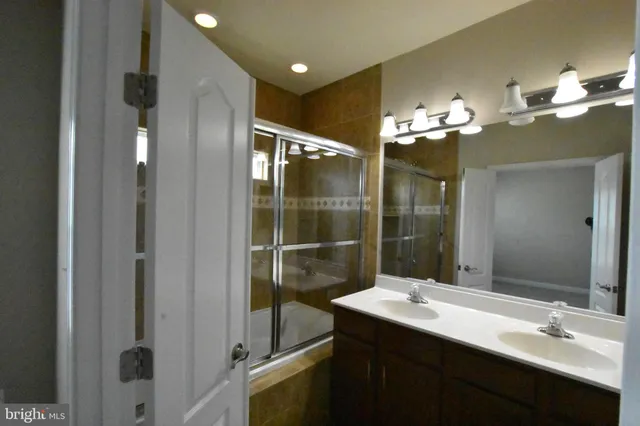 an empty room with closet and a chandelier fan