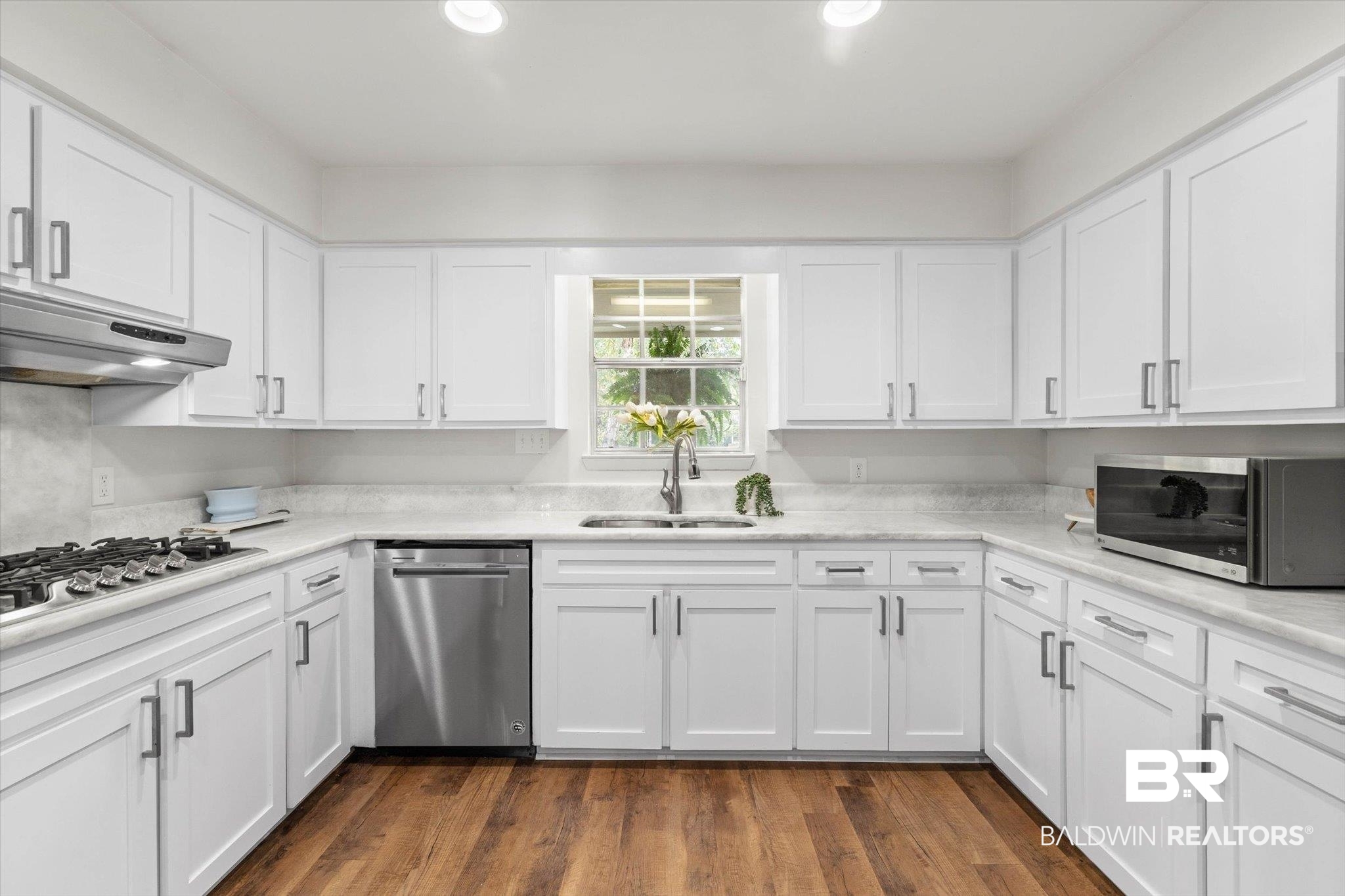 254 Woodlands Avenue Mobile, AL 36607 - Photo 44 of 50 Kitchen featuring white cabinets, dark wood-style flooring, appliances with stainless steel finishes, and recessed lighting