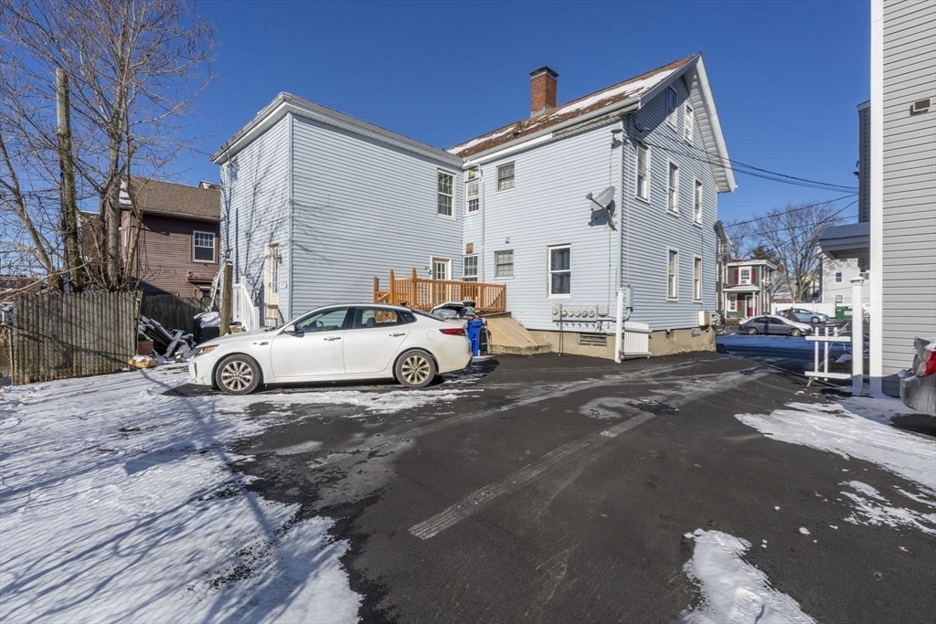 275 Bank Street Fall River, MA 02720 - Photo 16 of 20 a car parked in front of a white house