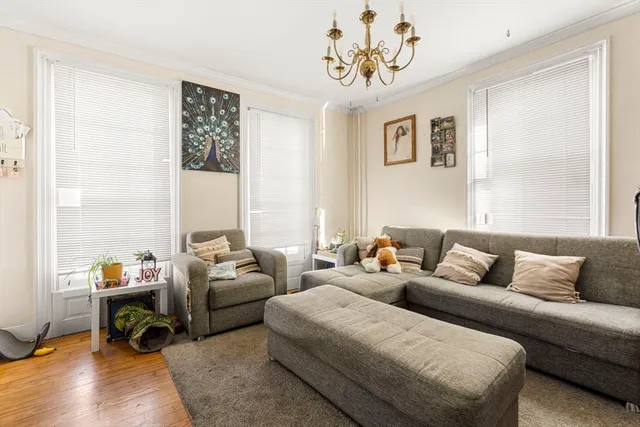 a living room with furniture a couch and a window