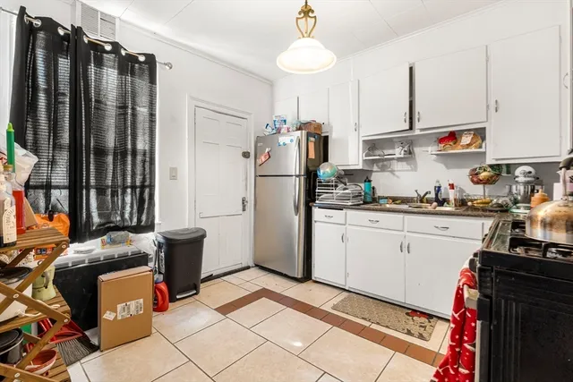 a kitchen with stainless steel appliances a refrigerator sink and microwave