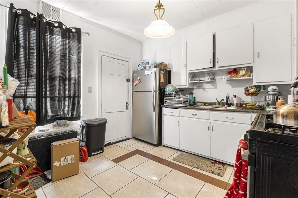 275 Bank Street Fall River, MA 02720 - Photo 8 of 20 a kitchen with stainless steel appliances a refrigerator sink and microwave