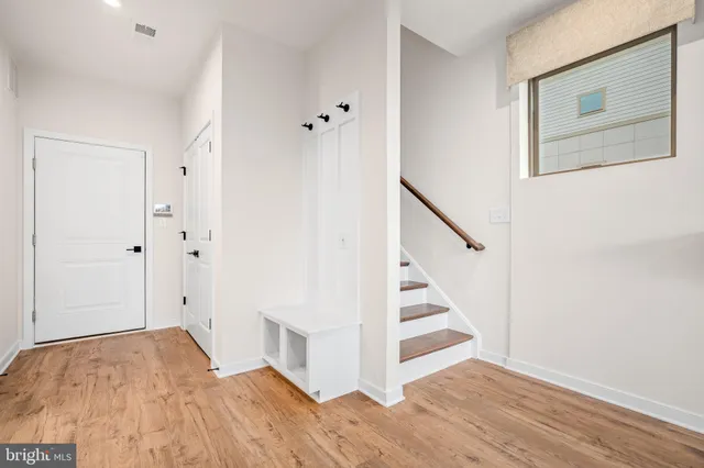 a view of a room with wooden floor and staircase
