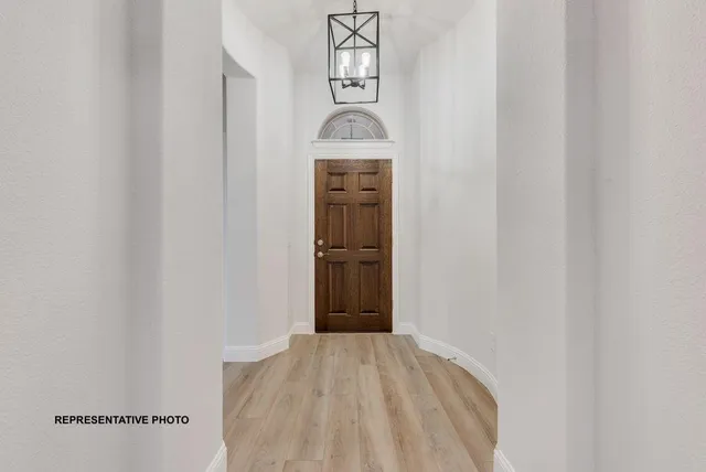 a view of a hallway to rooms