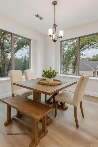 a view of a dining room with furniture window and outside view