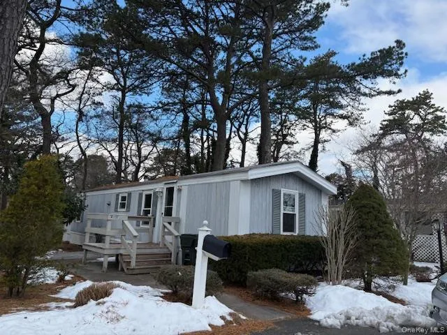 a view of a house with a yard covered in snow