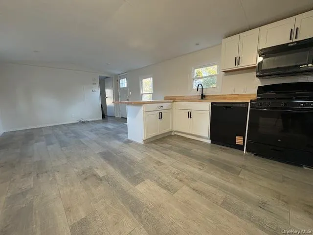 a kitchen with a refrigerator stove and cabinets